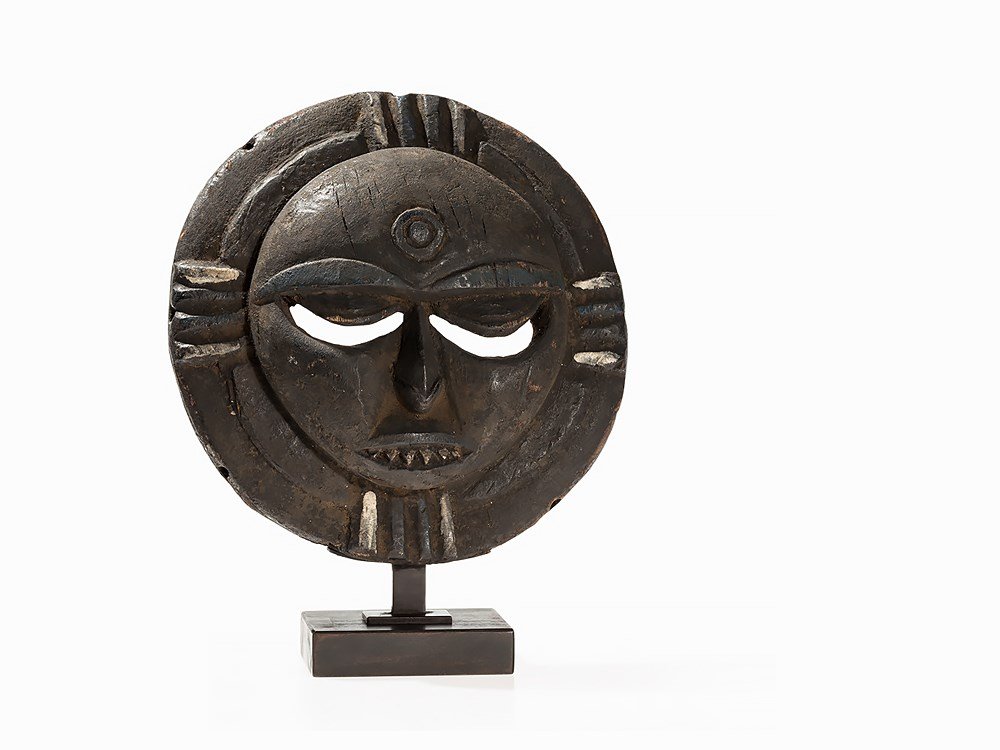Eket, Moon Mask, Nigeria, post 1940: Wood Eket people, Nigeria, post 1940 Eket moon mask with crescent eye slits, small nose and diminutive mouth Lateral designs along the outside edges and circle motif in the center of the forehead Encr
