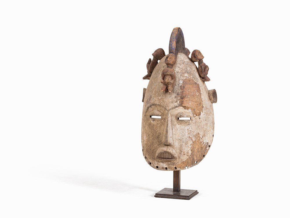 Jukun, Helmet Mask, Nigeria, post 1940: Wood Jukun people, Nigeria, post 1940 Large helmet mask with four ancestor figures sitting atop the upper portion of the mask Overall encrusted cream patina Height: 58 cm Provenance: Private collectio