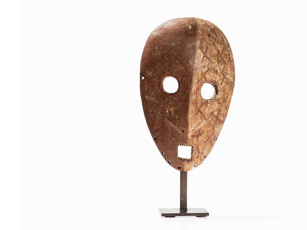 Ituri, Mask, Congo, post 1940: Wood Ituri people, Congo, post 1940 Ituri dance mask Bicolored facial treatment, one side being reddish brown and the other side being white-grey in color Classical motif of crosses and stars Height: