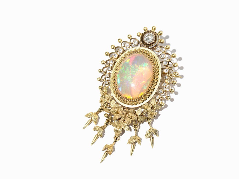 Opal Brooch of 18K Gold with 17 Diamonds, Europe, c.: 18 karat yellow gold Europe, around 1950 Hallmarked with purity mark at closing pin ‘585’ 1 big white translucent opal 1 diamond of c. 0.50 carat (SI, Top Wesselton G) 16 diamonds with a total wei