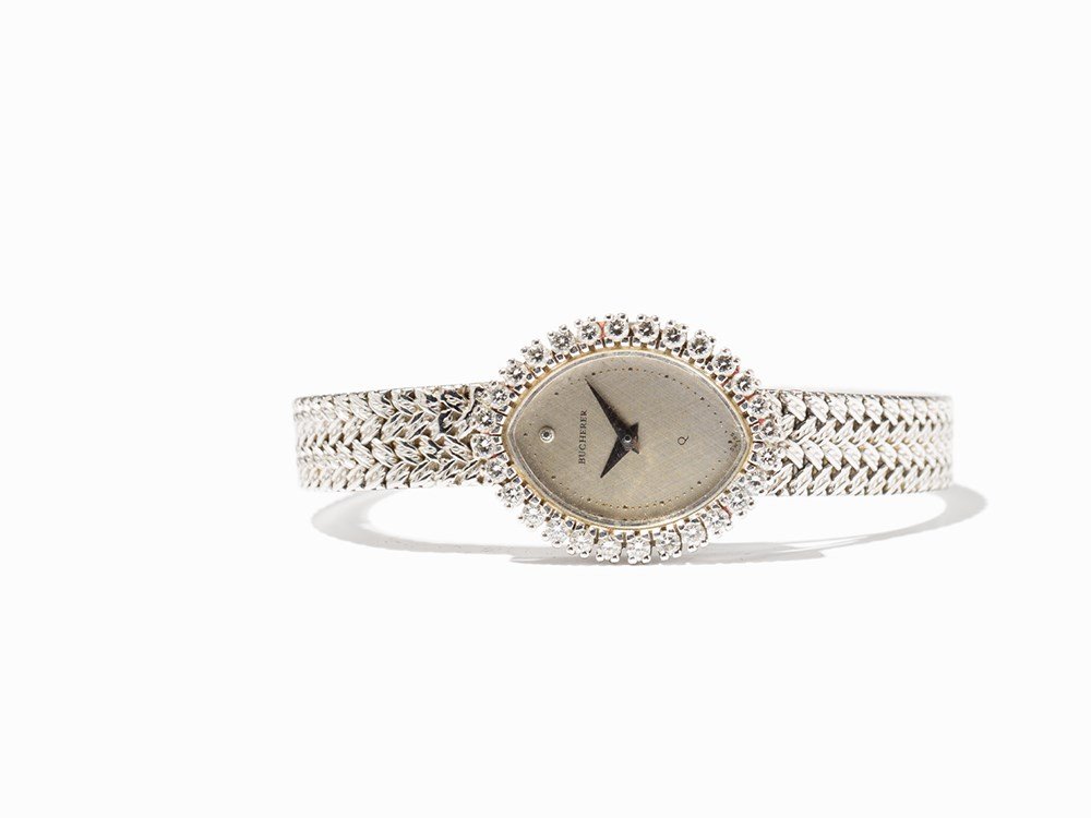 Bucherer Women’s Watch, Switzerland, Around 1990: Bucherer women’s watch Switzerland, around 1990 Quartz movement, hour, minute Silver dial, silver hands, diamond indices at 12 o’clock Watch case, strap and folding clasp of 18K white gold Watch c
