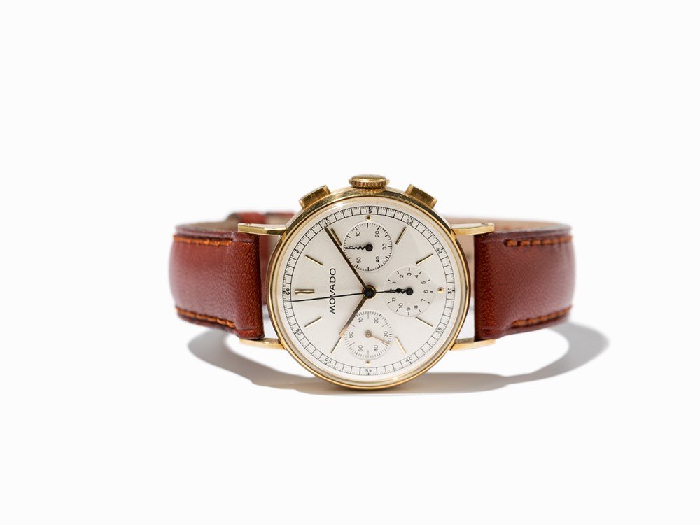 Movado Chronograph, Switzerland, Around 1945: Movado chronograph Switzerland, around 1945 Manual wind movement, Movado calibre; 17 jewels, hour, minute, second, chronograph Silver dial, gold and black hands Watch case of 18K gold Brown leather st