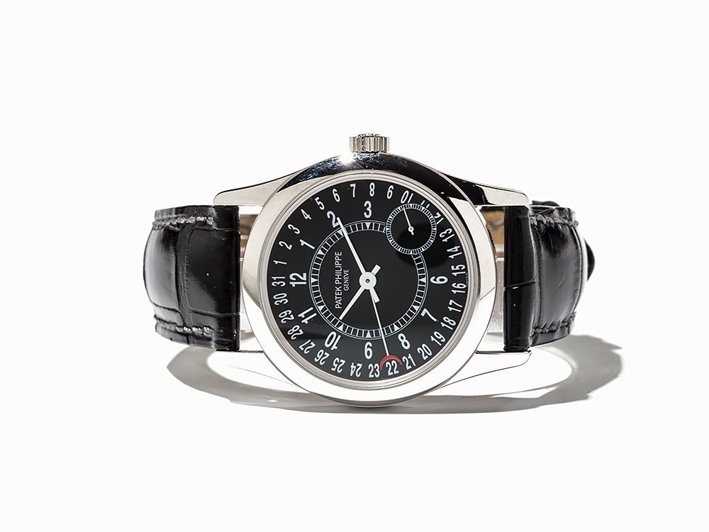 Patek Philippe Calatrava, Ref. 6000 G, Switzerland,: Patek Philippe Calatrava, ref. 6000 G Switzerland, around 2005 Automatic movement, 240 calibre; 27 jewels, hour, minute, second, date Black dial, white hands Watch case and original folding clasp of 1