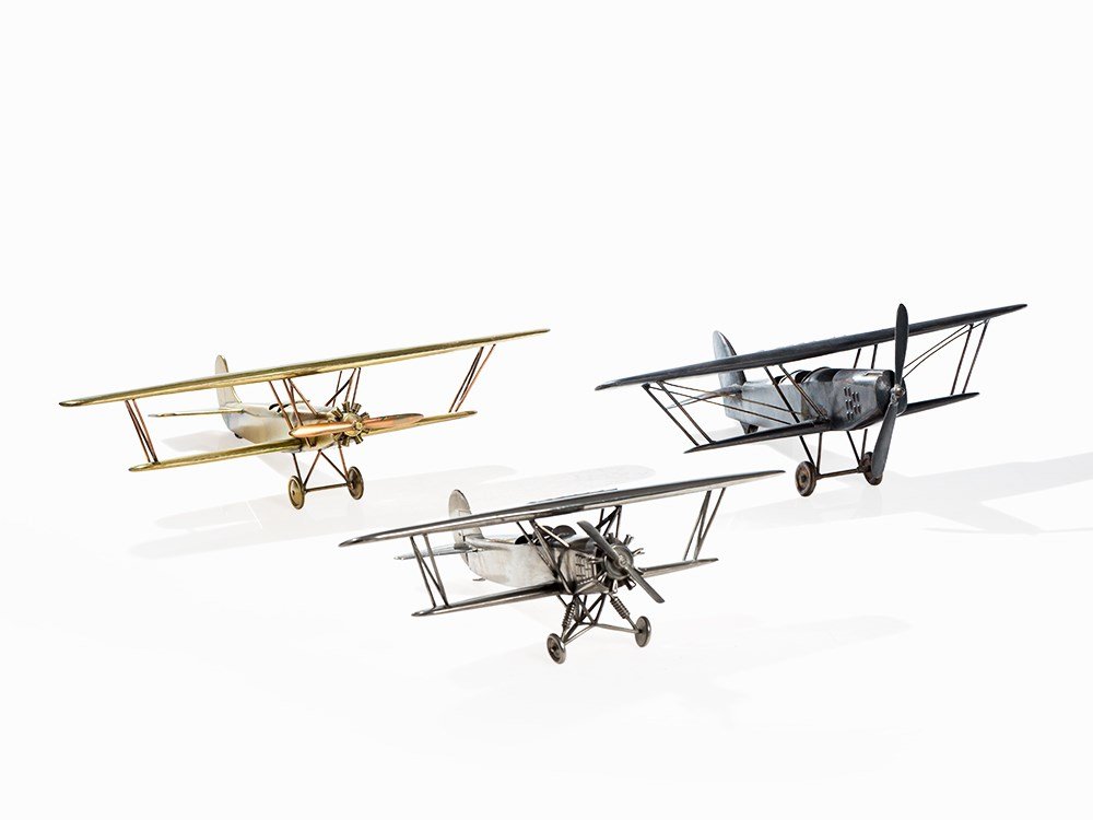 Three Large Models of Biplanes, Germany, 1930s: Metal, bronzed, brass, nickel-plated, copper Germany, 1930s 3 large models of well-known biplanes from the 1930s Lengths: 28-31 cm, wing spreads: 37-45 cm Good to very good condition Provenance: Austr