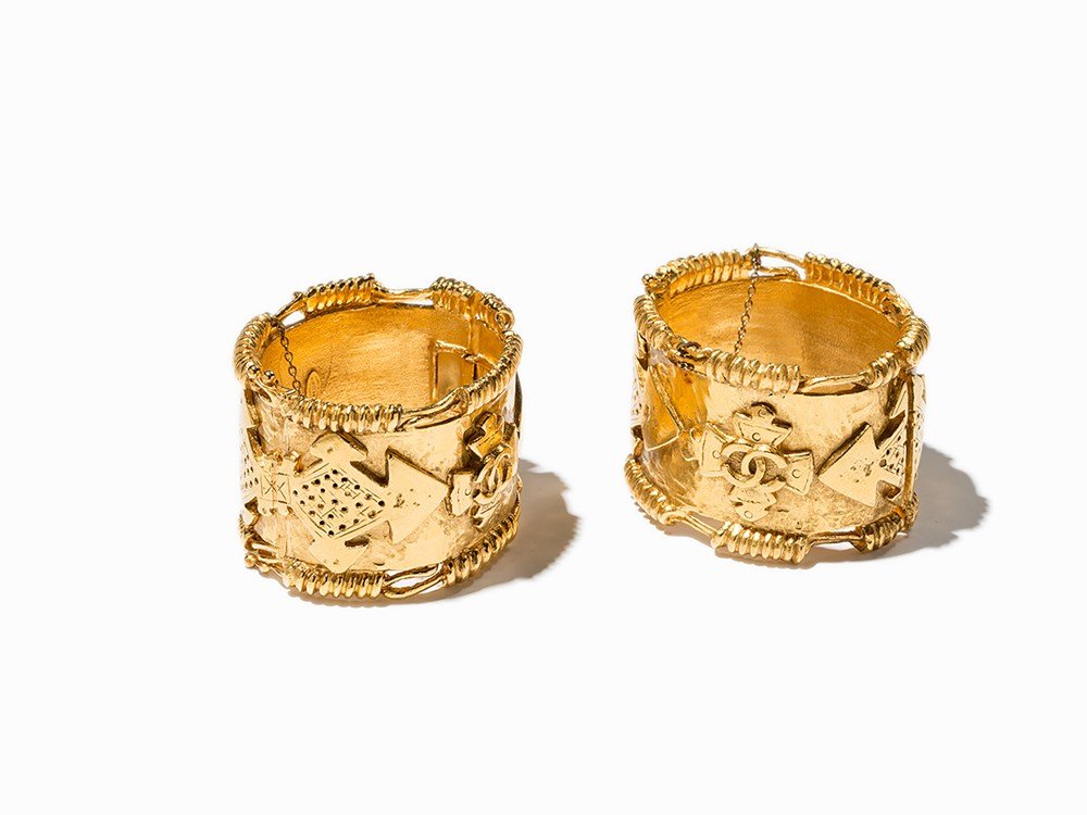 Chanel 2 Broad Gold Toned Bracelets, 1994: Gold-toned metal France, 1994 Chanel - French fashion company, founded by Coco Chanel (1883-1971) in 1909 With CC logo, branded Chanel and dated on the inside Double safety closure Original packaging
