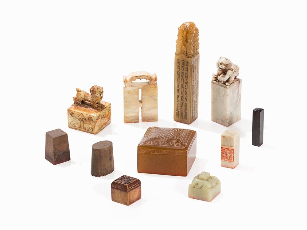 Set of with 11 Seals, Different Materials, 20th C.: Jade, soapstone, wood China, 20th century Included are eleven seals in different forms Richly decorated with Shou characters, bats, floral elements and archaistic mythical creatures E.g. a seal made o
