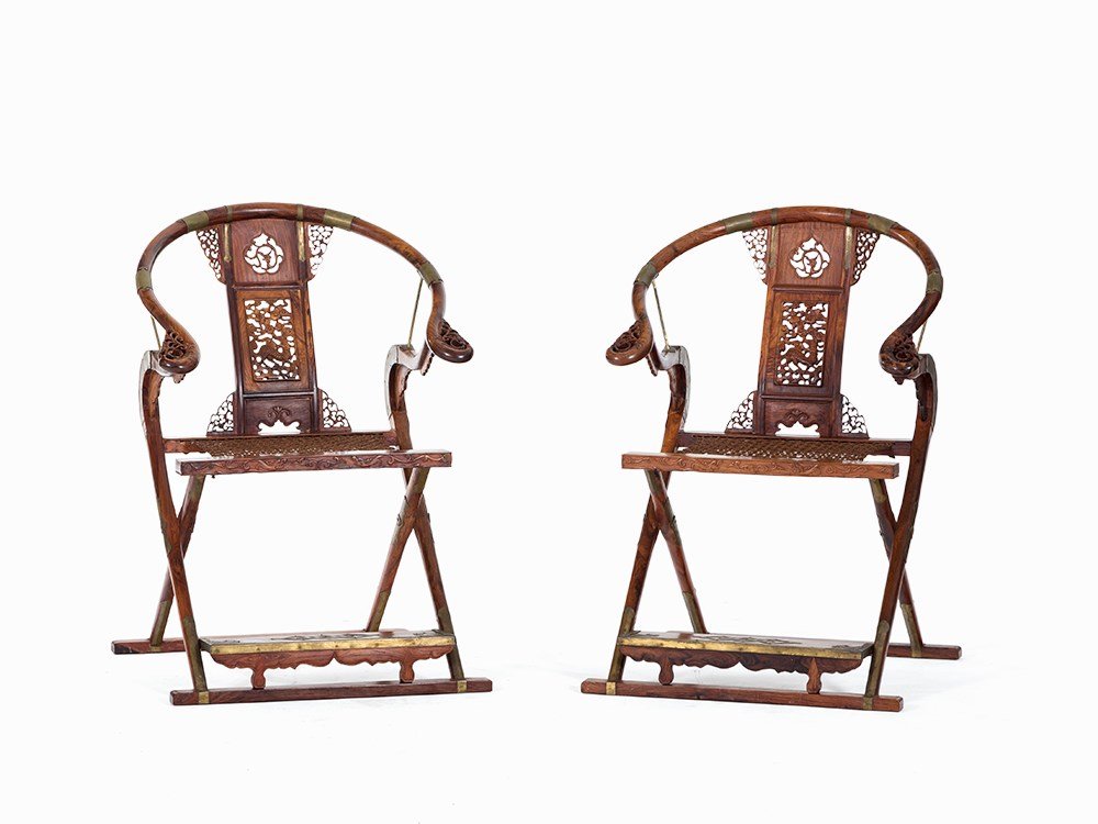 Pair of Huanghuali Folding Horseshoe Chairs with Qilin,: Huanghuali, brass fittings China, Qing dynasty (1644-1911) Horseshoe shape with slightly curved and ornate back splat Richly decorated back splat with a qilin among clouds Above a dragon in a curved c