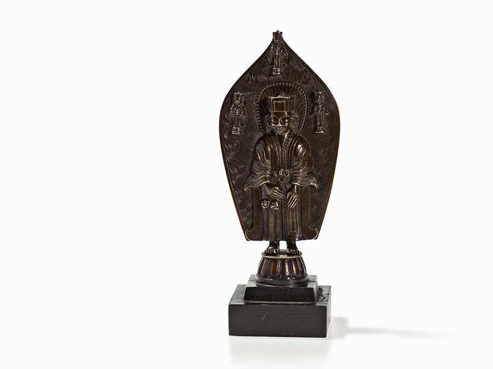 Bronze Figure of a Taoist Monk with Mandorla, Qing: Bronze China, Qing dynasty (1644-1912) Fine chasing Taoist monk with emanation in the flaming mandorla Endless knot on the belt Verso Chinese inscription ‘from the year Bing Cheng from the Han Dynas
