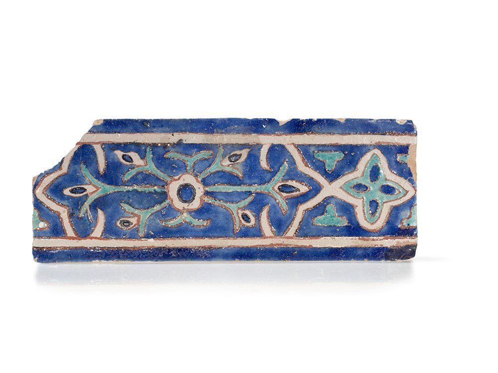 Timurid Cuerda Seca Pottery Tile, Samarkand, 15th C.: Rectangular tile in the cuerda seca technique Samarkand, Uzbekistan, 15th century Polychrome glaze with floral decoration Pale red body Dimensions: 33 x 12.5 cm Provenance: Important Austrian private 