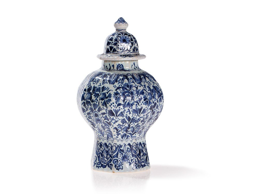 Lidded Faience Vase with Floral Decor, 18th Century: Bright faience chards with white ground and blue glaze Presumably Frankfurt, Germany, 18th century Marked underneath ‘J.V.’ Lidded vase with ornate, floral Chinoiserie decor Bulbous body with ribb