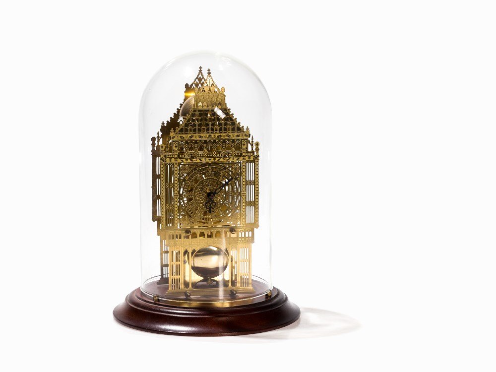 A Brass Skeleton Clock 'Big Ben', Glass Dome, England,: Brass, wood, glass England, 20th century Skeletonized movement, spring driven, lever escapement Hour-strike on above sitting bell, knife edge suspension, brass pendulum Skeletonized dial with hour-mar