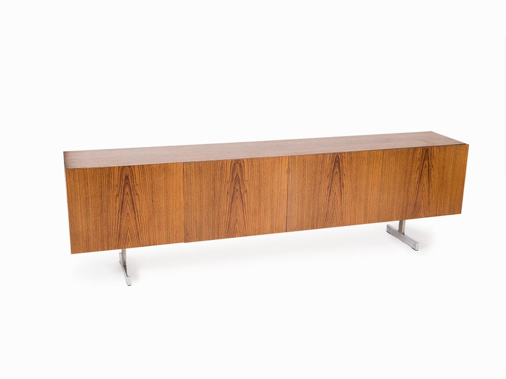 Large Sideboard in the Style of Dieter Waeckerlin,: Teak, veneered Germany, 1960s Body with four doors on 2 T-legs Inside one shelf and two drawers with one shelf respectively Fine figure of the wood The sideboard can be locked, key not available Dimen