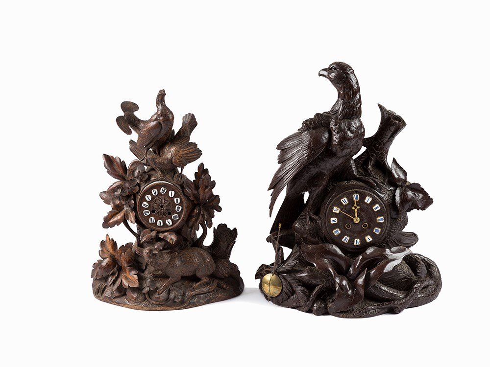 Two Figural Mantle Clocks in Black Forest Style, Late: Carved and stained wood Presumably Switzerland, larger clock around 1880 to 1890, smaller clock around 1860 to 1880 French made round brass plate movement Double barrel springs 8 day duration Striking