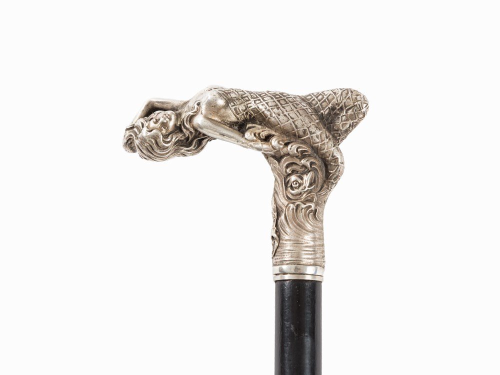 A Dandy Stick with Silver Handle Lolling Woman, Russia,: 84 zolotnik silver, cast, wood, ebonized, metal Warsaw, late 19th century Marked with assayer’s mark, purity and double-headed eagle mark as well as with further illegible hallmark Smooth, conical t