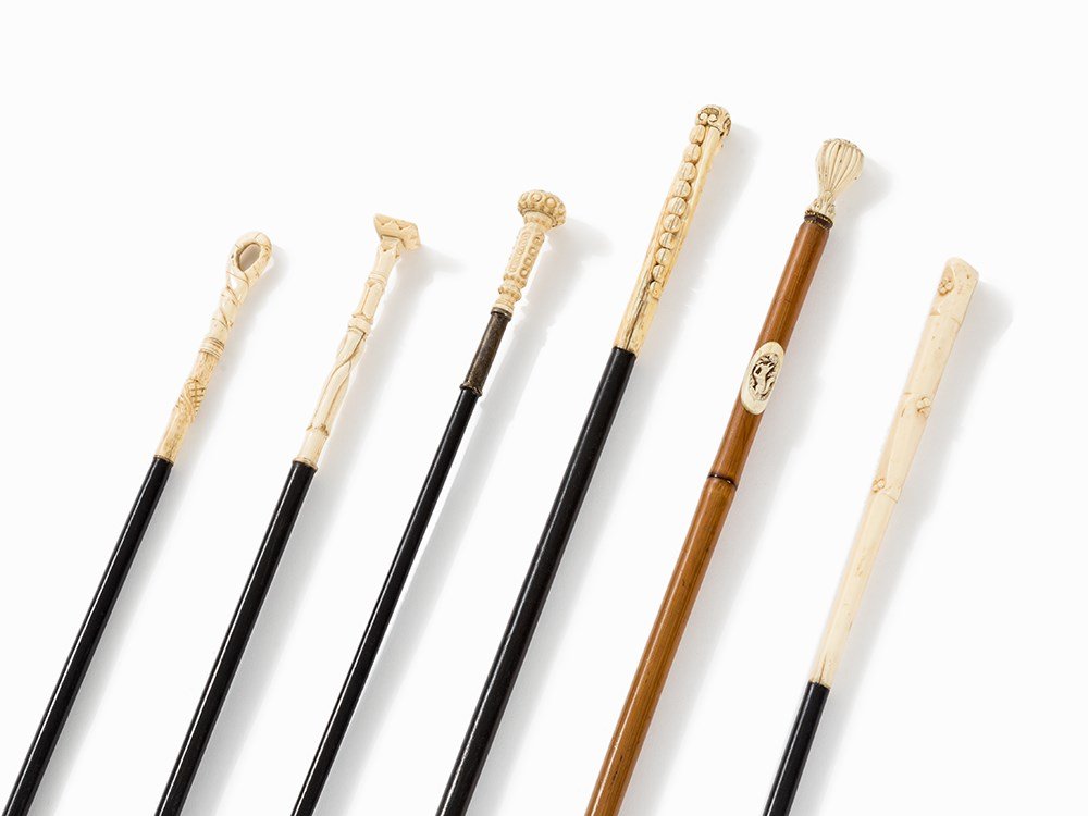 A Set of 6 Dandy Sticks with Ivory Handles, early 20th: Ebonized wood, reed, brass, carved ivory, partially blackened England and France, early 20th century. This item can only be delivered to an address within the EU. Slender, cylindrical or conical shaft