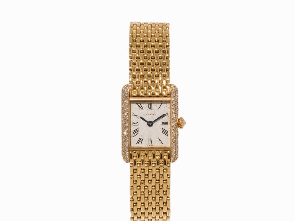 Cartier Diamond and Gold Lady’s Watch, c. 1990: Cartier diamond and gold lady’s watch Switzerland, c. 1990 Quartz movement, hour, minute Silver dial, blued hands Watch case, original strap and folding clasp of 18K gold Watch case edge set with di