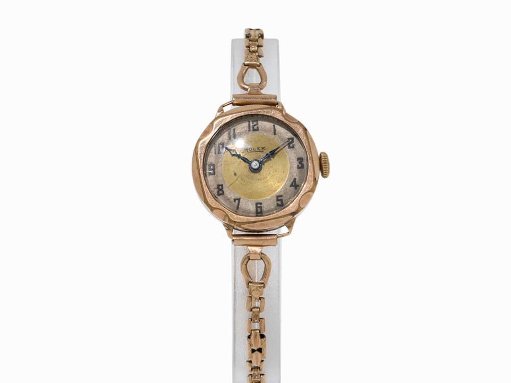 Rolex, Early Lady’s Watch, Switzerland, c. 1930: Rolex, early lady’s watch Switzerland, c. 1930 Manual wind movement, hour, minute Silver and gold dial, blued hands Watch case of 9K rose gold Gold plated strap with folding clasp Watch case hallmar