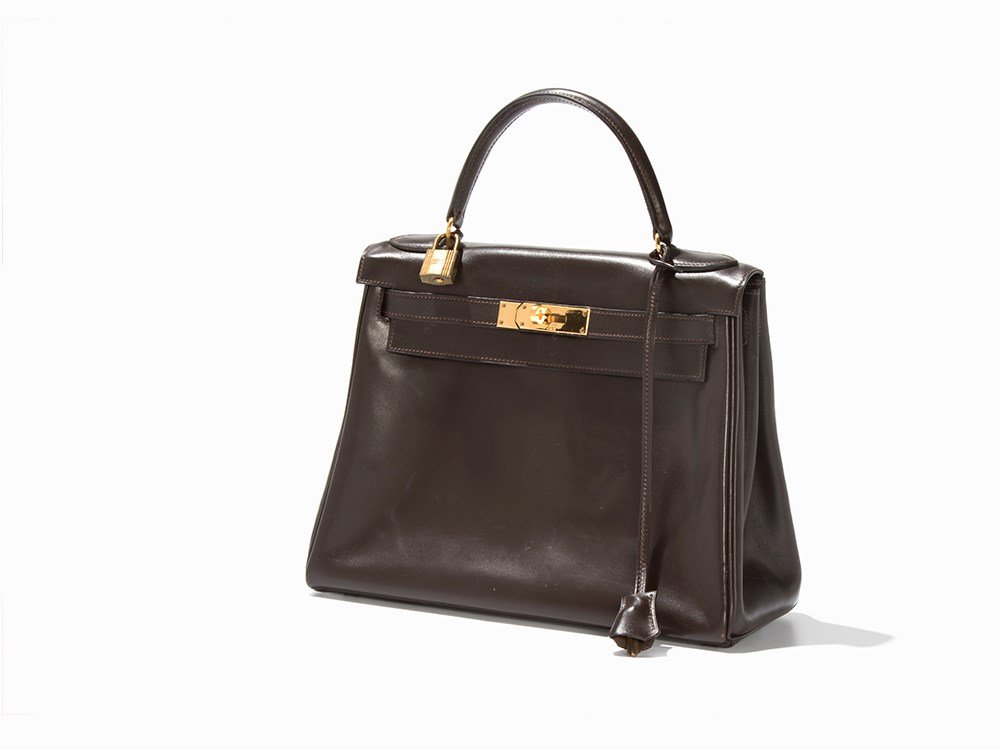 Hermès, Kelly Bag, Dark Brown Leather, 1975 : Dark brown smooth leather, gold-coloured metal Paris, France, 1975 Hermès, established 1837 - French luxury goods manufacturer On leather above buckle stamped in gold 'HERMÈS / PARIS / MADE IN FRANC