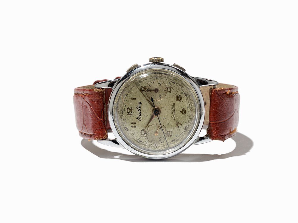 Breitling Chronograph, Switzerland, Around 1940: Breitling chronograph Switzerland, around 1940 Manual wind movement; 17 jewels, hour, minute, subsidiary second Silver dial, black hands Watch case of stainless steel Brown leather strap with pin buck