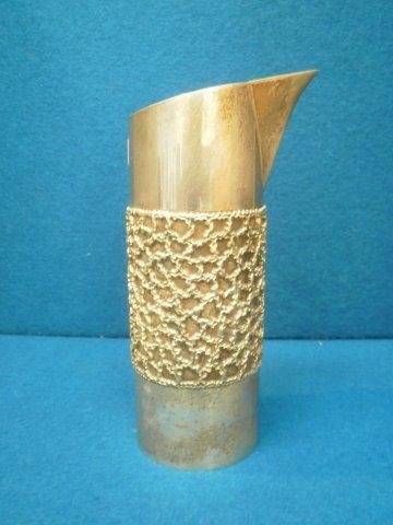 A parcel gilt silver jug designed by Stuart Devlin: A parcel gilt silver jug designed by Stuart Devlin, the cylindrical form with applied wrigglework decoration, London 1979, 17oz.