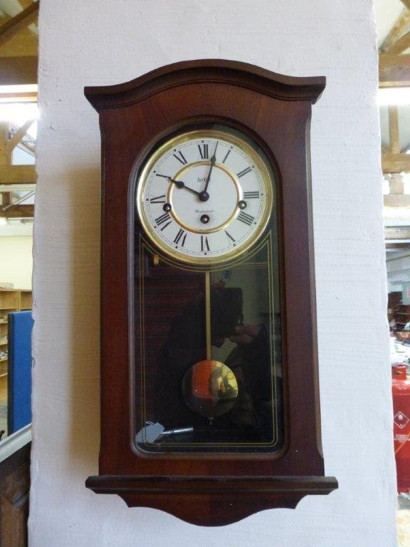 A contemporary Acctim westminster chime wall clock.
