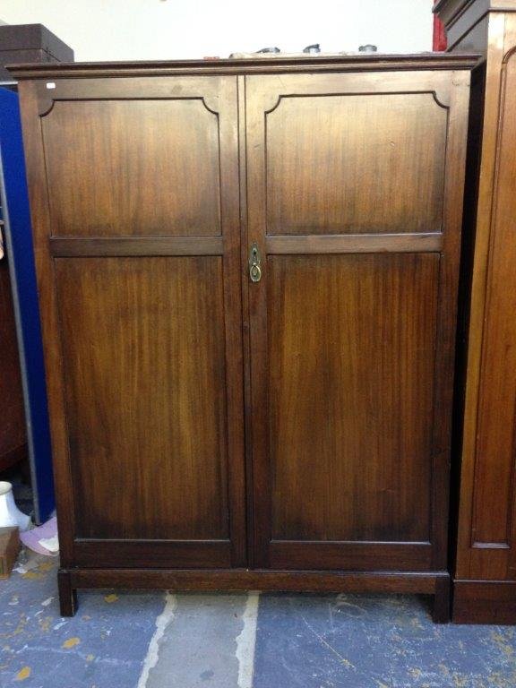An Edwardian mahogany gentleman's fitted wardrobe.: An Edwardian mahogany gentleman's fitted wardrobe.