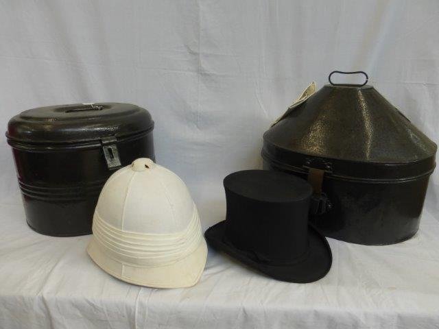 A pith helmet in a toleware tin hat box and a Lincoln: A pith helmet in a toleware tin hat box and a Lincoln Bennett & Co. Burlington Gardens Old Bond Street collapsible top hat also in a toleware tin hat box with a pair of cream leather gloves.