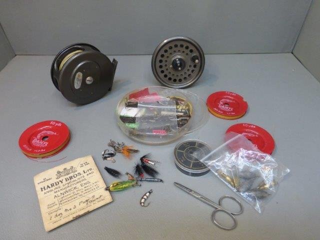 A box of assorted fly fishing equipment including an: A box of assorted fly fishing equipment including an intrepid wet and dry interchangeable reel, a Hardy Bros Ltd. pack of hooks, spare line, flys etc.