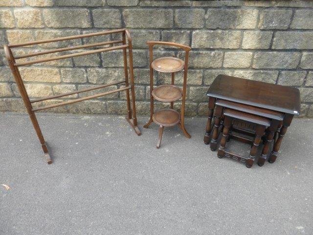 A three tier cake stand, a towel rail and a nest of: A three tier cake stand, a towel rail and a nest of three Ercol style tables.