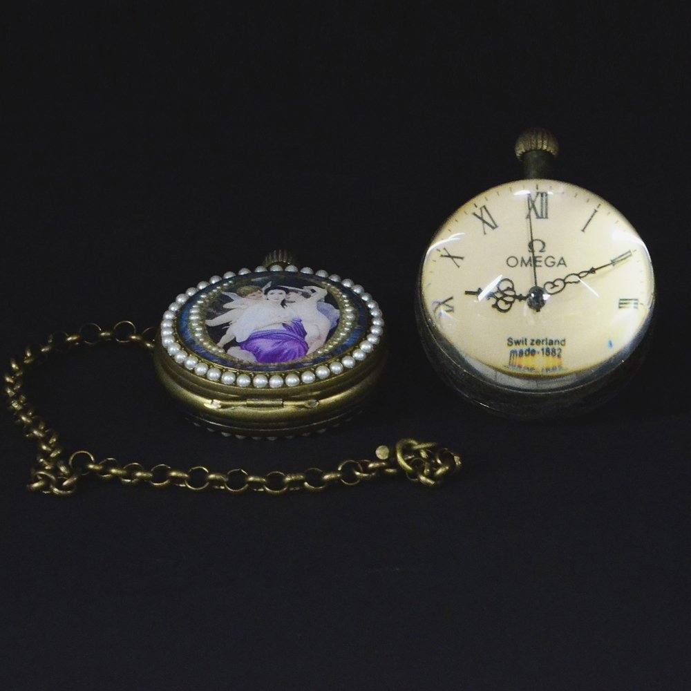 TWO ANTIQUE POCKET WATCHES: 兩個古董表 One is an OMEGA watch made in Switzerland and has a half crystal ball design. The other is LONDON branded watch also made in Switzerland and has a ring of pear