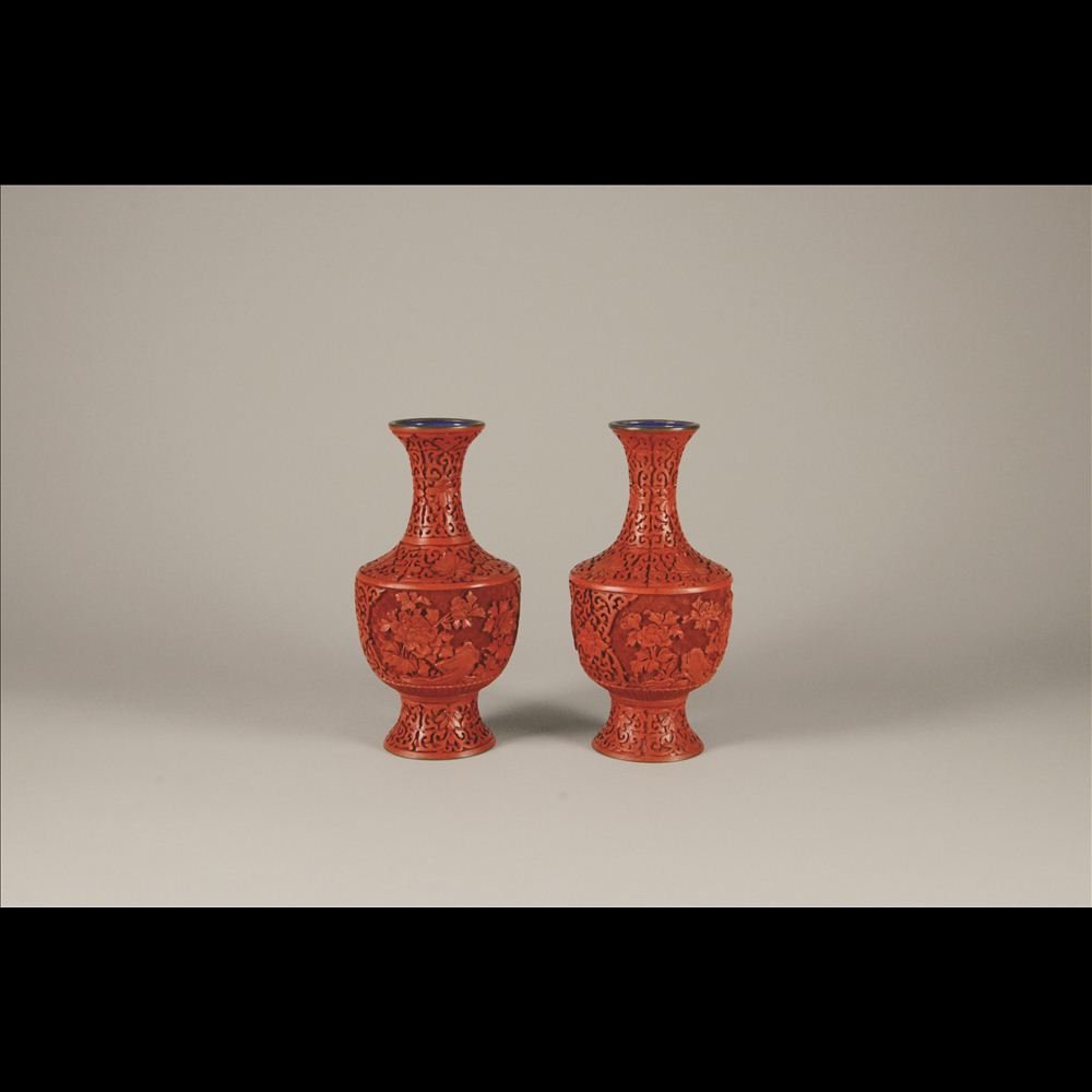 PAIR OF CARVED CINNABAR VASES: Bronze based with front & back carved panels consisting of floral designs H: 9”