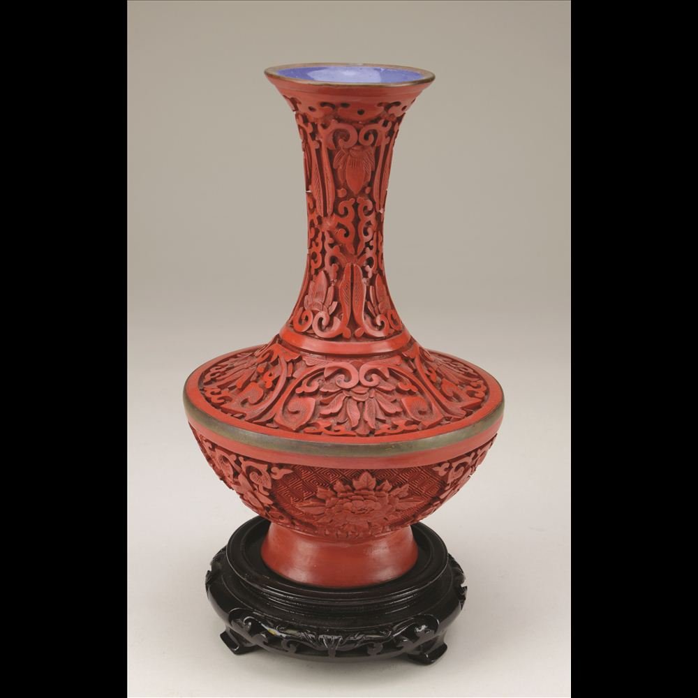 CARVED CINNABAR LACQUER VASE: Bronze base with an extra bronze rim around the body of the vase. H: 8”