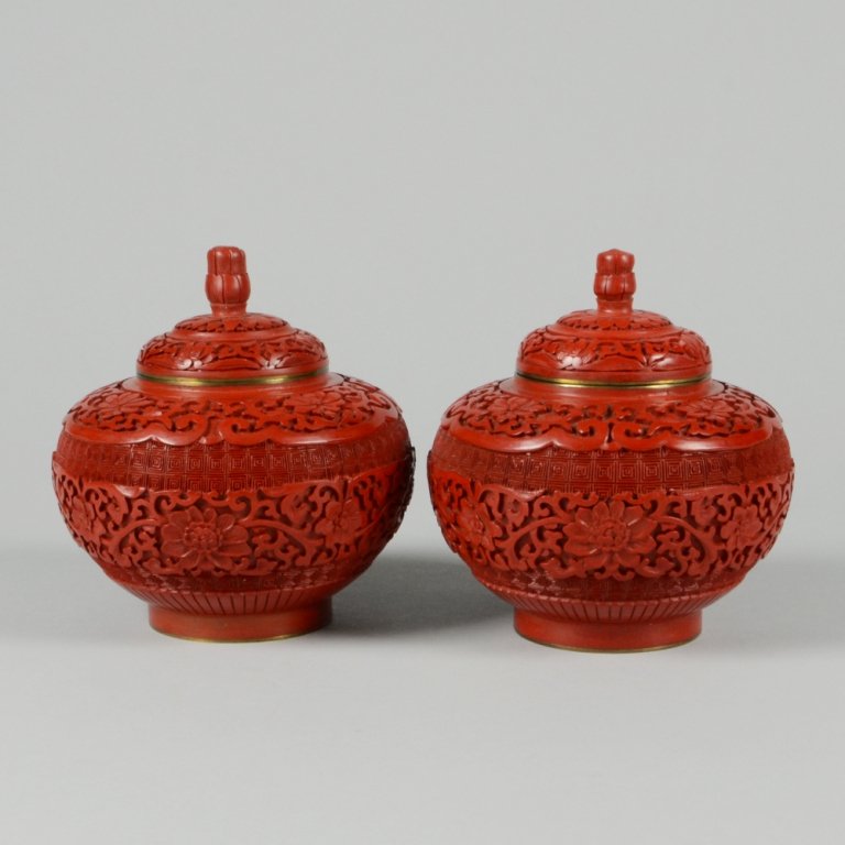 PAIR OF CARVED CINNABAR LACQUER JARS: Front and back panels with floral designs. H: 5 ½" D: 5"