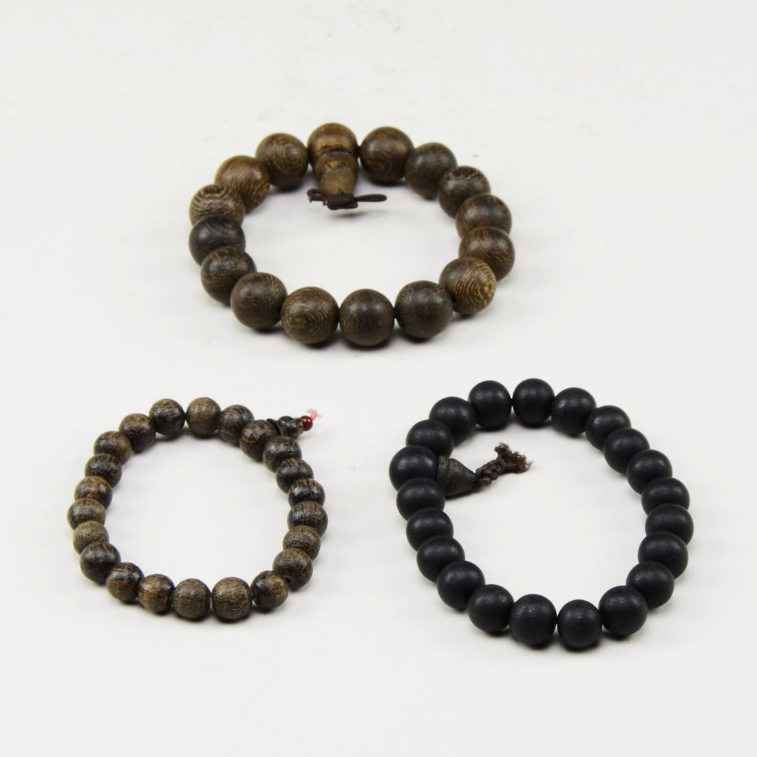 3 WOODEN BEADED BRACELETS: Quality wood. (D: 2 1/2")