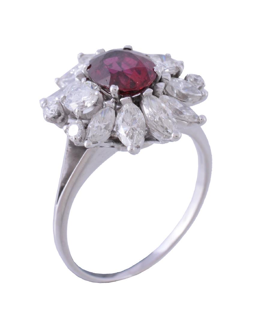 A ruby and diamond cluster ring, the central oval cut (1 of 3)