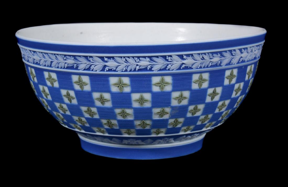 A Wedgwood tri-colour jasper 'diced' slop bowl from a: A Wedgwood tri-colour jasper 'diced' slop bowl from a solitaire dejeurner set, circa 1790, decorated with a chequer pattern of quatrefoils beneath a stiff-leaf border, the interior lapidary polished,