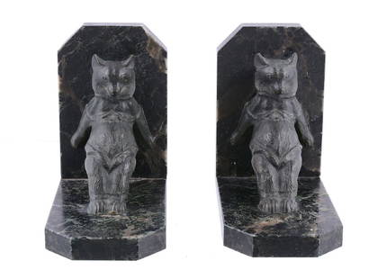 Maurice Frecourt , a pair of bronze and marble bookends: Maurice Frecourt (French, b. 1890), a pair of bronze and marble bookends , the bears bracing themselves against the uprights, dark brown and green patination, named to the marble, 17cm high