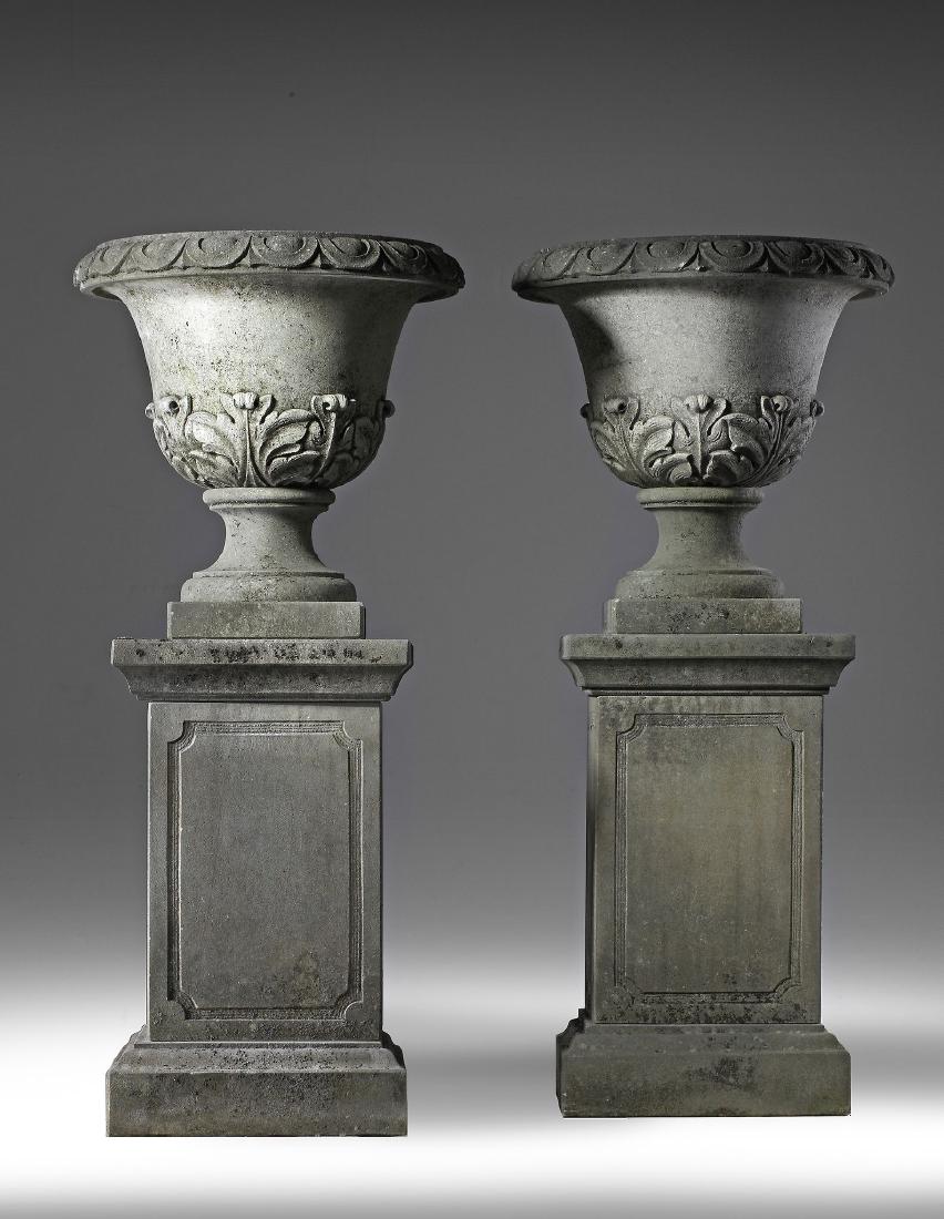 pair of carved limestone garden urns on plinths , pair of carved limestone garden urns on plinths ,