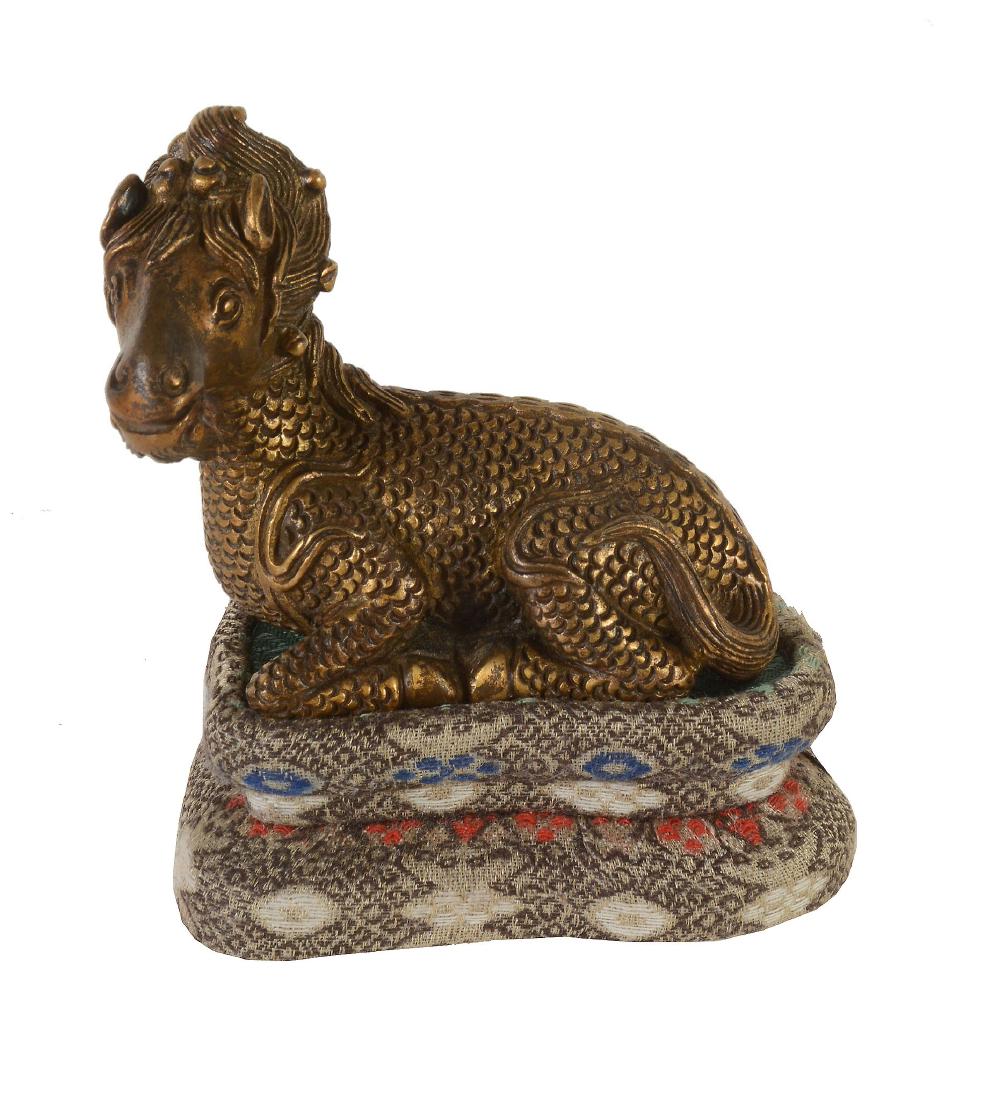 A small Chinese gilt-bronze Xiezhi- form scroll weight (1 of 5)