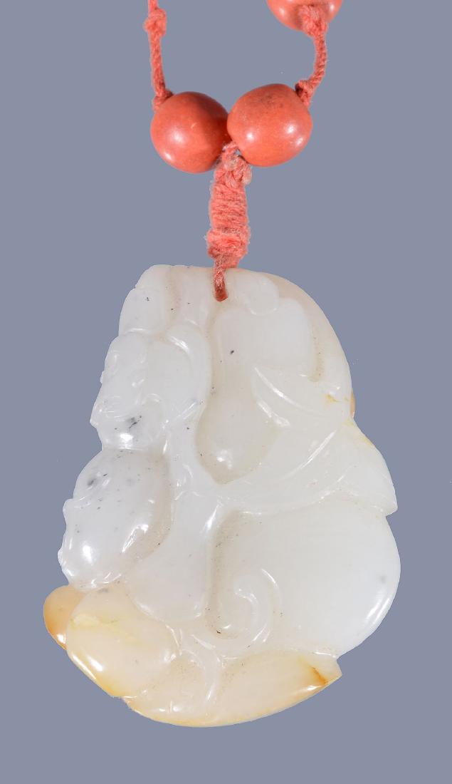 A Chinese white jade and russet pendant, Qing Dynasty (1 of 4)