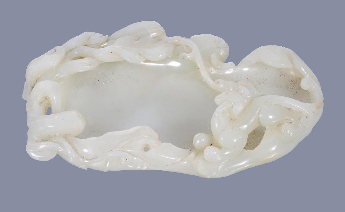 A Chinese pale celadon jade brush washer, carved as a (1 of 3)