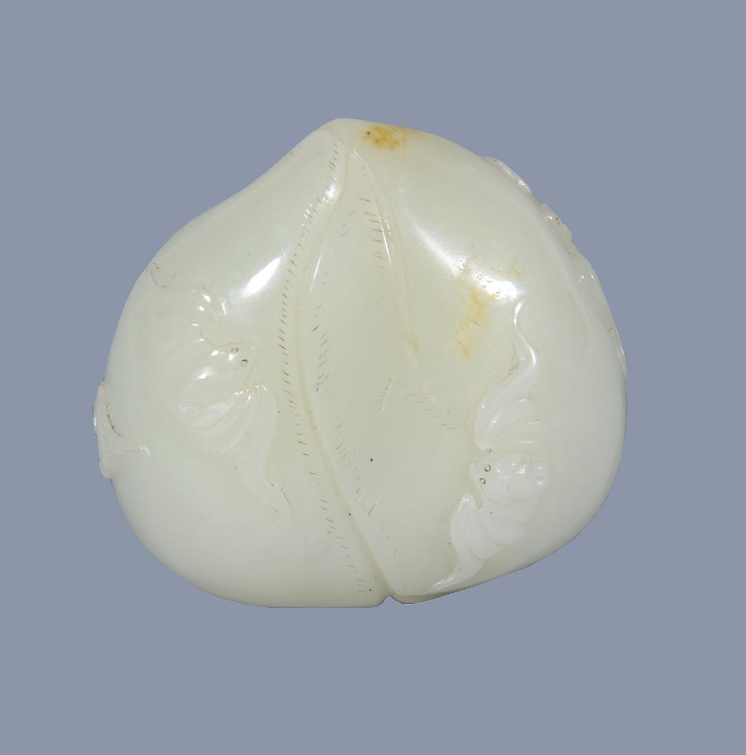 A Chinese white and russet jade carving of a peach (1 of 4)
