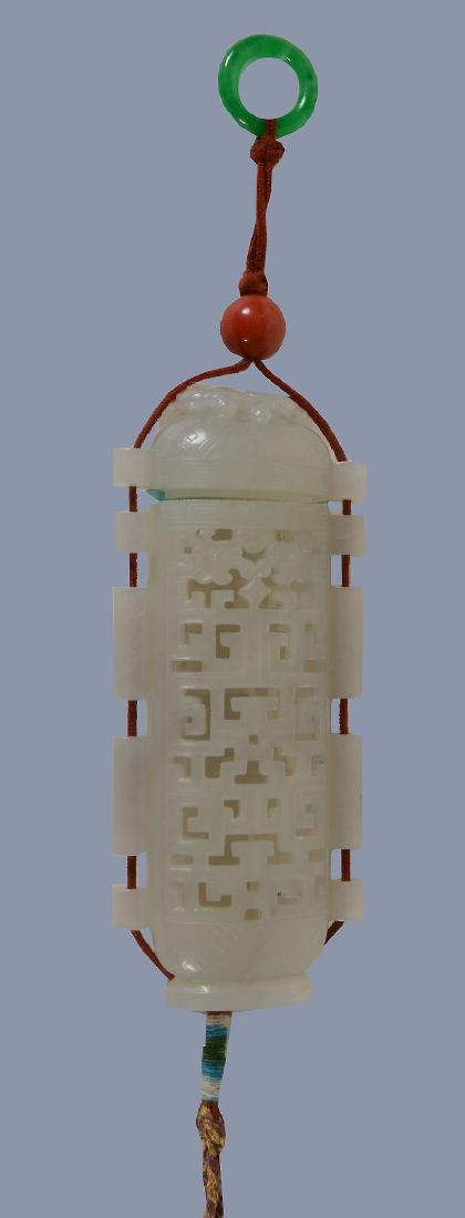 A Chinese white jade openwork pomander and cover: A Chinese white jade openwork pomander and cover, of pierced rectangular form and the domed cover carved with a chilong , strung with cord, 10cm high x 4.2cm wide x 1.7cm deep