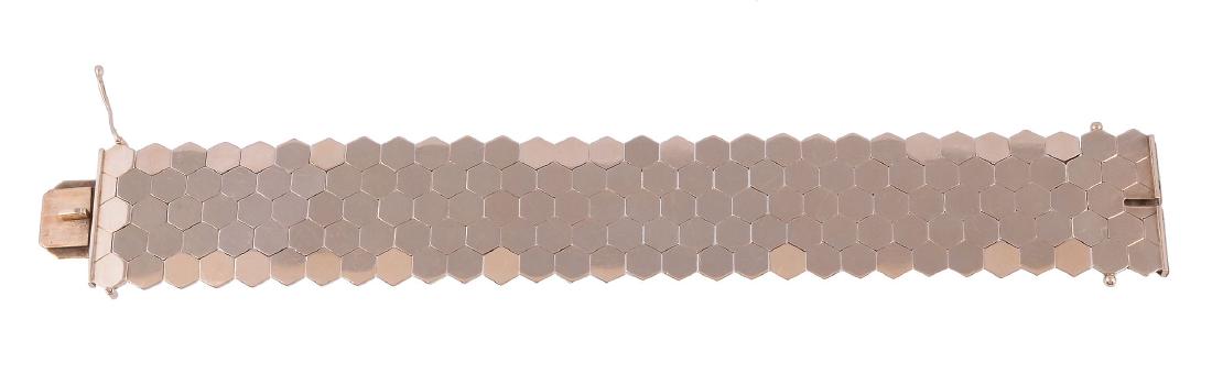 A gold coloured bracelet, the panel bracelet composed (1 of 1)