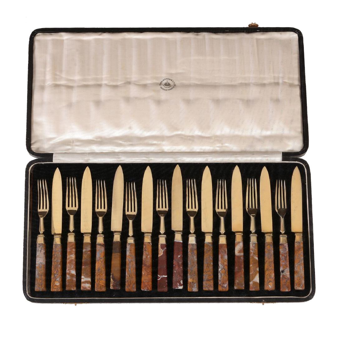 A set of nine silver gilt dessert knives and forks with: A set of nine silver gilt dessert knives and forks with agate handles by Carrington & Co. Ltd, London 1912, in a case bearing the label ' Carrington & Co. Ltd', 130 Regent Street, the knives 19.5cm lo