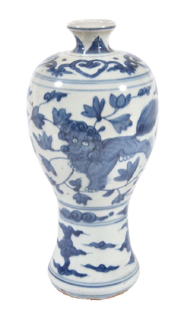 A Chinese provincial blue and white vase: A Chinese provincial blue and white vase, Meiping, 17th century, painted with a Buddhist lion amongst foliage, 23cm high 17世纪 青花狮子梅瓶