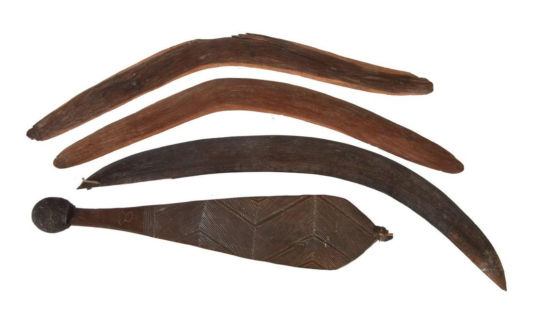 An Western Australian Aboriginal spear thrower: An Western Australian Aboriginal spear thrower, with zig-zag carved surface to one side, brown patina, 52cm long and three Australian Aboriginal boomerangs, varying patinas, approximately 60cm, 62cm a
