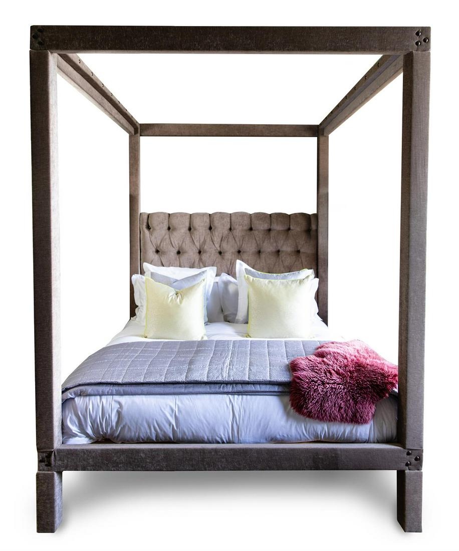 A CRUSHED VELVET CLAD FOUR-POSTER BED, MODERN: A CRUSHED VELVET CLAD FOUR-POSTER BEDMODERNWith button upholstered padded headboard262cm high, 222cm long, 202cm wide. Please note that the bed cushions and covers are not included with this lot