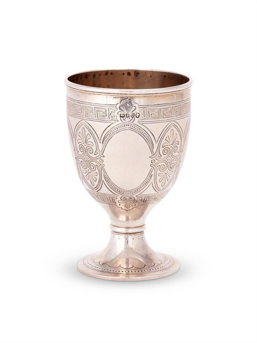 A VICTORIAN SILVER GOBLET, JAMES BARCLAY HENNELL,: A VICTORIAN SILVER GOBLETJAMES BARCLAY HENNELL, LONDON 1877Engraved with vacant oval panels divided by double palmettes, within Greek key bands, the spreading foot with arcaded and beaded bands13cm (5