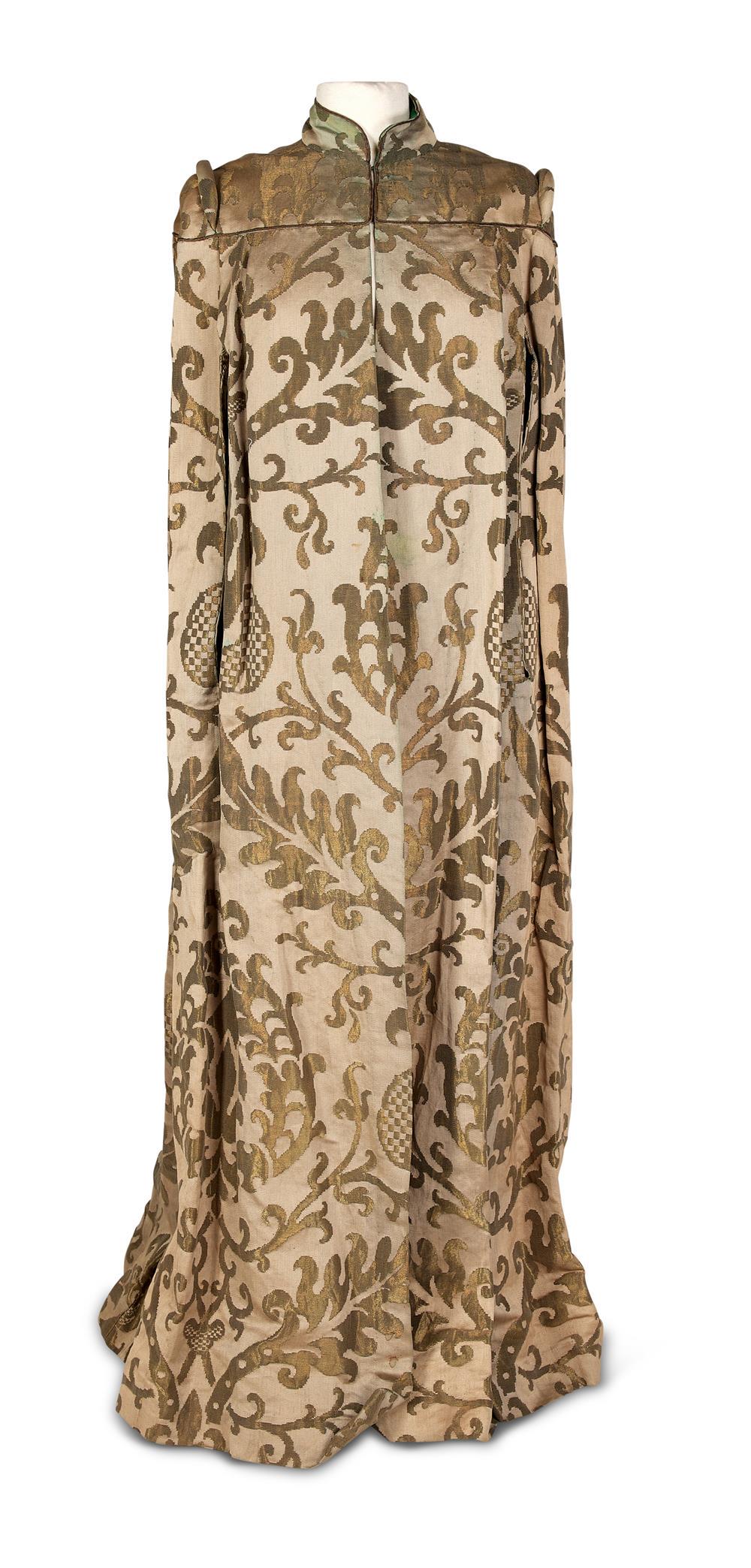 DAME EDITH INTEREST, A CELADON GREEN SILK AND GILT: DAME EDITH INTERESTA CELADON GREEN SILK AND GILT METAL BROCADE FULL LENGTH EVENING CAPE FIRST HALF 20TH CENTURY Custom made with furnishing fabricW ith stand up collar to shaped and piped and shaped y
